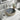 Round ceramic countertop basin with dark speckled bowl and leaf-patterned outer rim