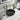 Round matte black ceramic vessel sink basin with central drain opening on countertop