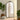 Black arched freestanding mirror with scrollwork metal frame, reflective glass