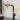Black and gold kitchen faucet with dual control column and rotating sprayer stream