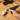 Handheld corded rotary tool using a small sanding bit on a wooden block
