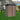 Outdoor metal garden storage shed with pent roof, brown panels and black door frame