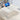 Foldable laptop bed table with cup holder, white tray holding a laptop and keyboard