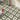Marble-look vinyl floor tile with light marble base, dark bordered squares, diamond motif