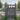 Wooden security gate, gray finish, vertical bars with horizontal brace and hinge side