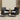 Set of 2 black rattan armchairs with white seat cushions and padded armrests