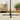 Dark metal cantilever parasol base cross stand with central pole on carpet