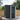 Lockable black metal storage shed with open door showing interior shelves