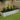 Silver oval raised garden bed planter box with black liner and horizontal ridges