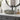 Ceramic countertop washbasin with dark speckled bowl and raised leaf border