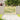 Wooden garden gate with vertical pickets and diagonal brace, light wood