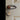 Chrome door knob cylinder with gold keyhole on light wood door