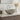 Round light gray ceramic vessel sink with pop-up drain, on countertop