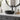 Matte black round ceramic vessel sink basin with central drain and black faucet