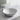Light grey round ceramic vessel sink on stone countertop with pop-up drain