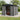 Metal garden storage shed with apex roof and sliding doors, open interior shelves