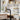 Black kitchen faucet with gold sprayer and pull-out spout, with water spray patterns