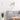 Square acrylic mirror tile panel with grid divisions on a living room wall