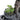 Tabletop fountain side view: green plant accents beside stone rocks and wooden posts