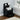 Black bedside table with open shelf and two drawers, styled with decor