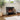 Freestanding black electric fireplace heater with LED flame effect behind glass panels