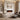 White wall-mounted electric fireplace with burning flame effect and rectangular mantel surround.