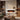 White wall-mounted electric fireplace with glowing flames and clean-lined rectangular design.
