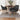 Dark grey velvet dining chairs with curved arms and gold-tone legs, set around table