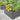 Two raised garden beds, gray slatted galvanized steel, filled with yellow flowers