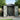 Anthracite storage shed with open double doors, gable vents, and interior wall panels