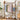 Brown bamboo clothes rack with hanging rail, side ladder shelves, rolling bottom shelf