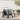 Grey collapsible pet stroller with canopy handle and four rolling wheels