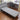4-Fold Folding Bed, light gray padded mattress on wheels with black metal frame