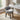 Silver grey velvet upholstered accent stool with curved back, nailhead trim, dark legs