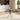 Rectangular glass-top metal table with chrome cross legs, styled in living space