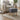 Dark grey linen footstool with tufted seat and light wooden legs