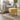 Yellow linen footstool with tufted seat and light wooden legs