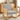 Grey upholstered rocking chair with woven rattan back panels and light wood rockers