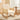 Beige linen upholstered rattan rocking chair with curved wood base and armrests