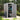 Gray plastic garden storage shed with lockable side door, pent roof, visible interior shelves