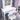 White vanity desk with illuminated mirror, drawer, and padded stool seat
