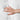 White quilted king hybrid mattress with a hand pressing into the surface