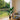 Artificial banana tree in black pot with faux green leaves and stems