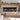 Inset electric fireplace with black trim and glowing flames over stacked logs