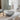 Light grey round ceramic countertop basin with chrome mixer tap and pop-up drain