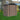 Metal garden storage shed with apex roof, double doors, and vented upper roof panels