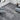 Dark gray marble-look peel-and-stick vinyl floor tiles with white veining