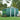 Green metal garden storage shed with apex roof, double doors, and front roof vents