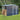 Metal garden storage shed with log stack compartment, sliding door and apex roof vents, dark