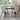 Light gray tufted armless dining chair with padded seat and back, black metal legs